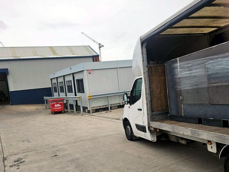 Specialist load secured inside a blue curtain-side van